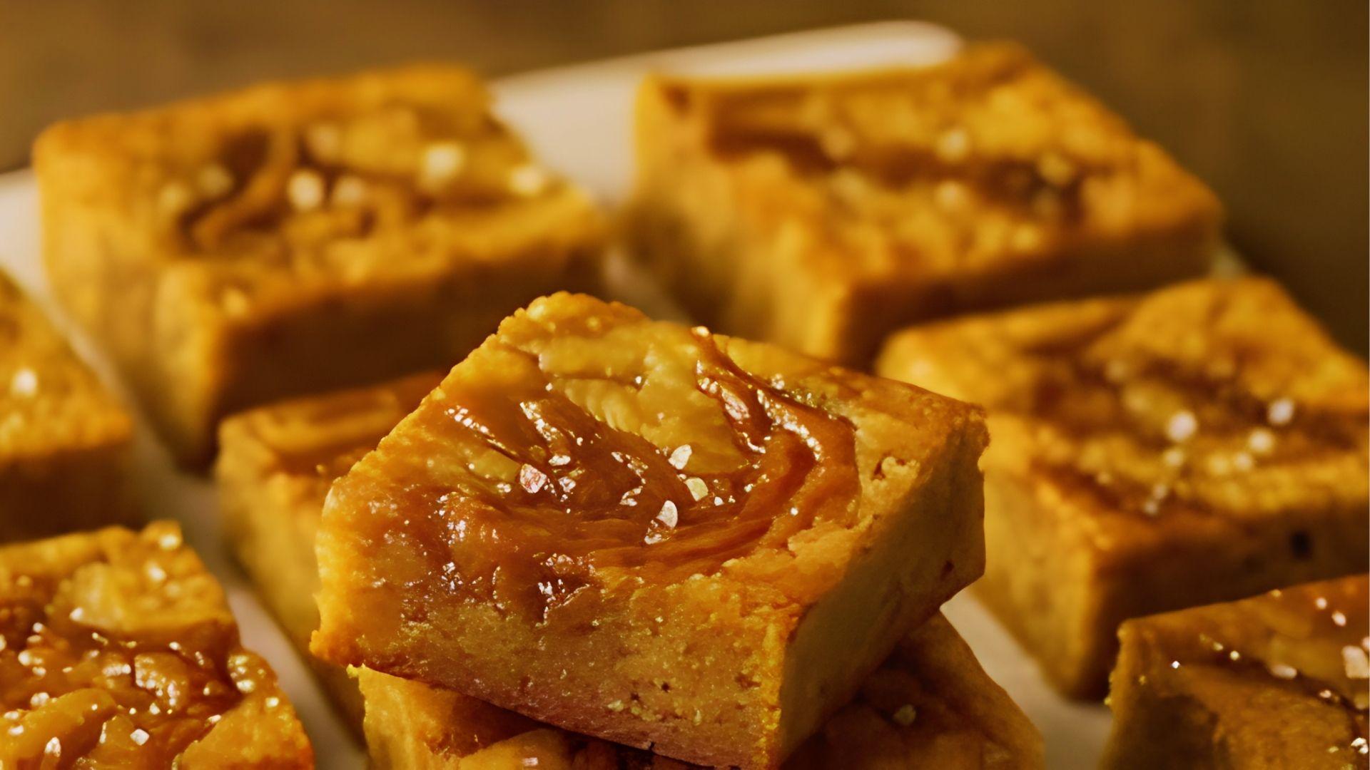Gooey cannabis infused caramel blondie squares stacked on white plate for simple dessert edibles recipes