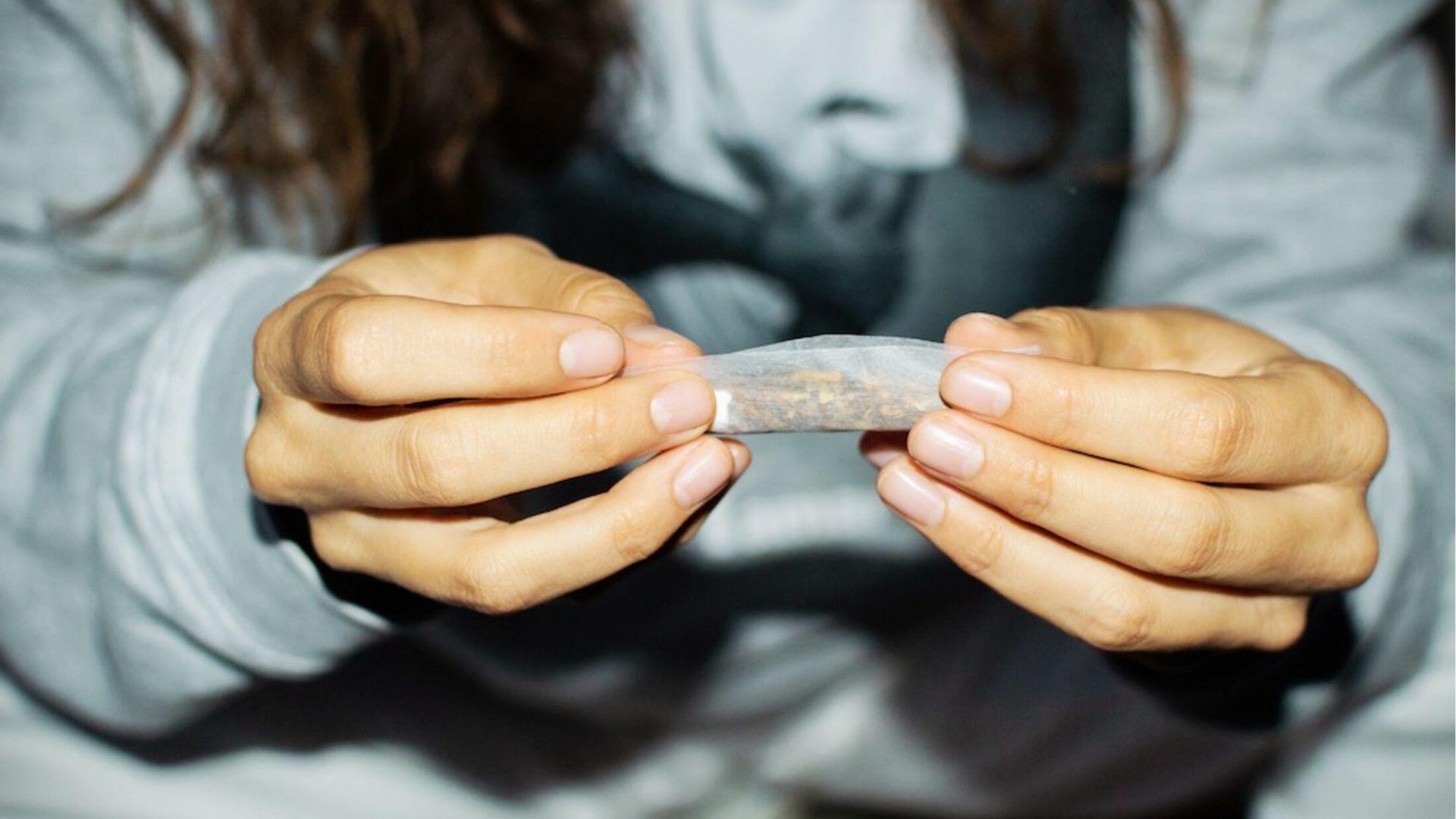 Person’s hands rolling cannabis joint, showing alternative consumption method when edibles don’t work