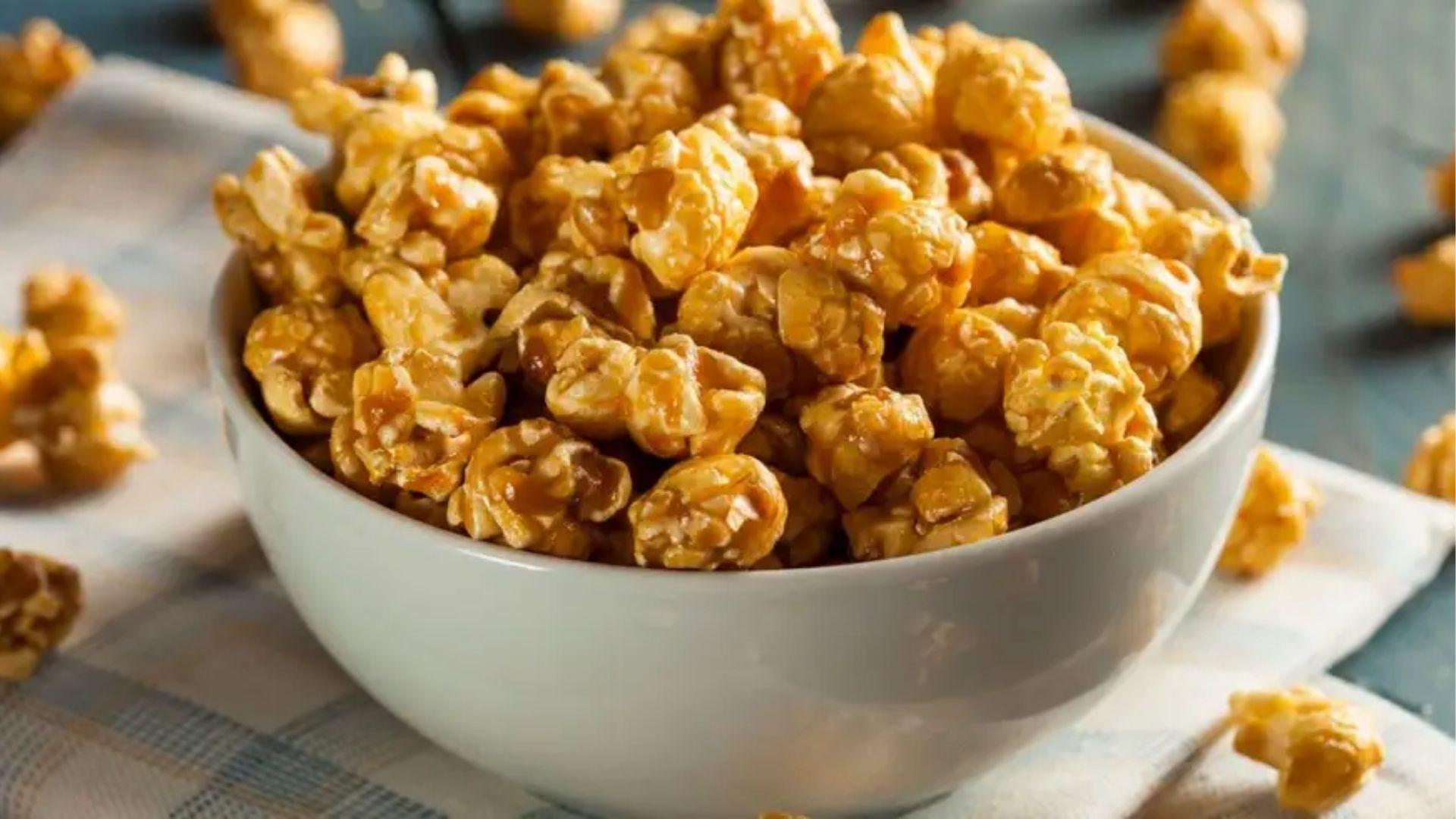 Bowl of golden caramel popcorn with cannabis infusion on linen cloth for sweet easy cannabis snack recipes