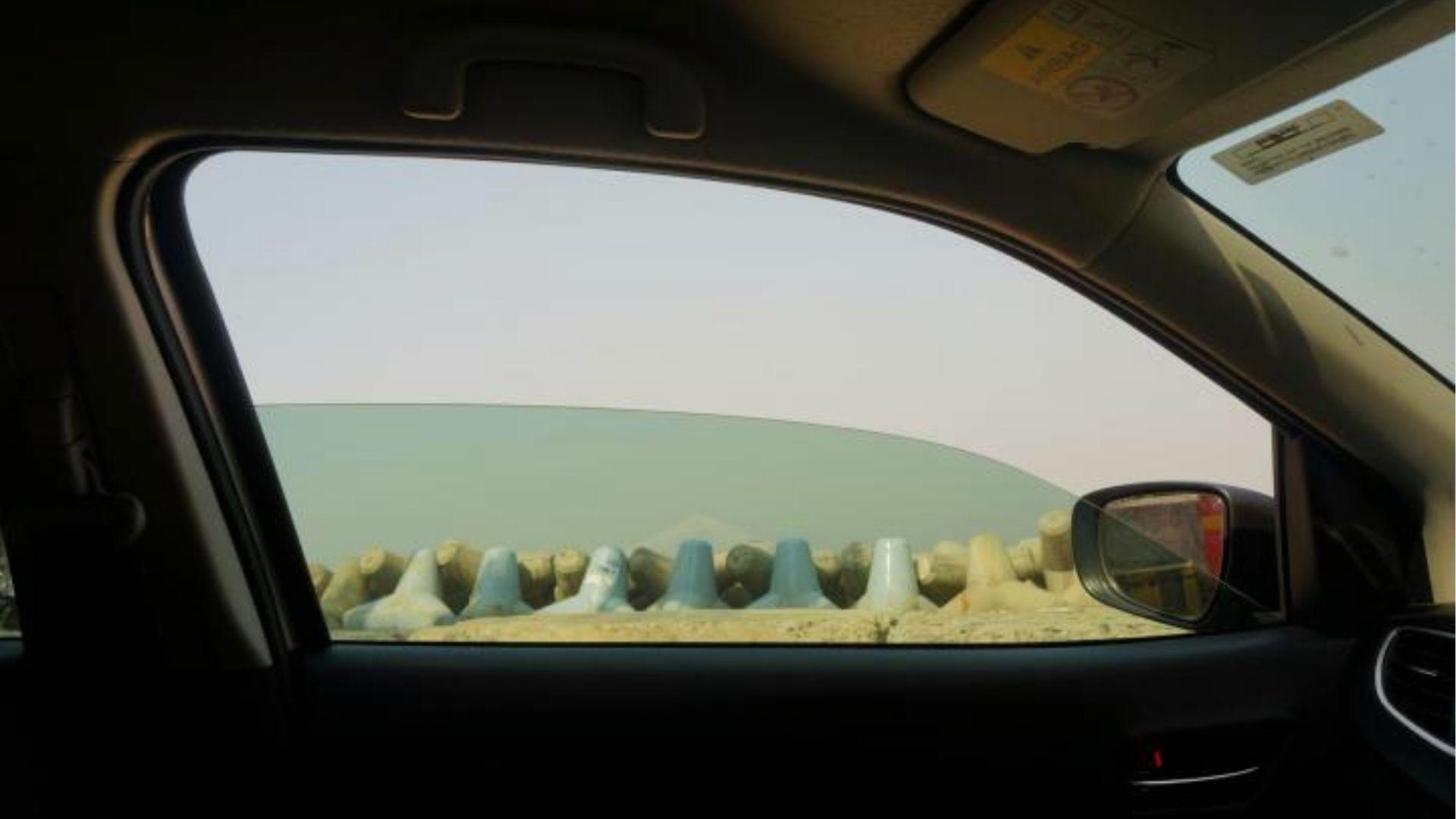 Car window rolled down for natural ventilation to air out weed smell quickly and safely